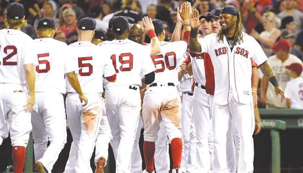 Boston Red Sox designated hitter Hanley Ramirez (Right) high fives his teammates after defeating the New York Yankees in Boston. PICTURE: USA TODAY Sports