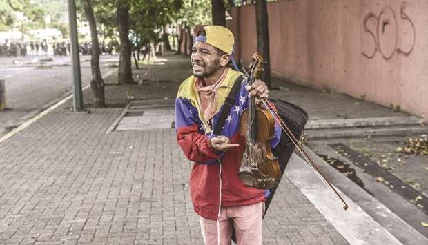Wuilly Arteaga crying after Venezuelan security forces destroyed his violin.