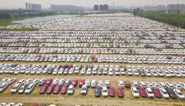 New cars are seen in a parking lot of the Brilliance factory in Shenyang, Liaoning province. China posted better-than-expected growth in the second quarter, official data showed yesterday, but authorities warned that the worldu2019s second largest economy faces external and internal risks.