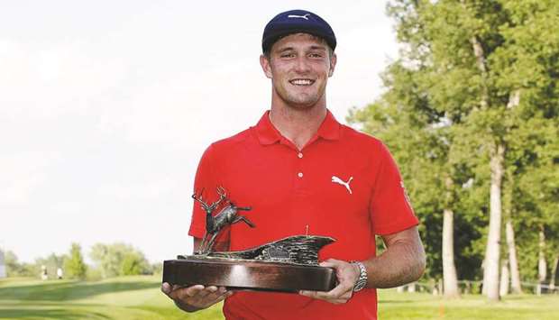 Bryson DeChambeau poses with the championship trophy following the final round of the John Deere Classic in Silvis, Illinois, on Sunday. (AFP)