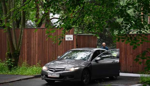 A man stands by his car as he leaves a settlement, which houses a US diplomatic recreational house, in Serebryany Bor park in Moscow on July 13, 2017.