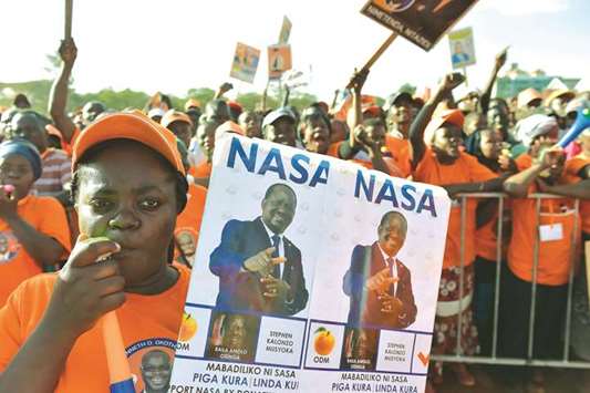 Supporters of the National Super Alliance party listen to the opposition leader and presidential candidate Raila Odinga during a campaign rally in Nairobi yesterday.