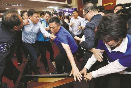 Ruling Democratic Progressive Party legislator Chao Tien-lin (left) scuffles with opposition Kuomintang legislators during a budget meeting for an infrastructure development programme, at the Legislative Yuan in Taipei yesterday.
