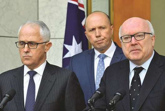 Australiau2019s Attorney-General George Brandis, Australian Minister for Immigration Peter Dutton and Prime Minister Malcolm Turnbull attend a media conference at Parliament House in Canberra.