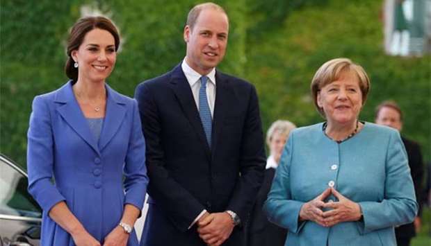 German Chancellor Angela Merkel receives Prince William, the Duke of Cambridge and his wife Catherine, the Duchess of Cambridge, at the Chancellery in Berlin on Wednesday.