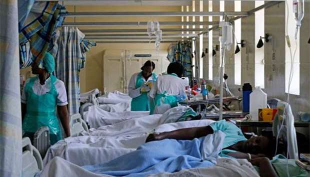 Medical practitioners attend to a cholera patient inside a special ward at the Kenyatta National Hospital in Nairobi on Wednesday.