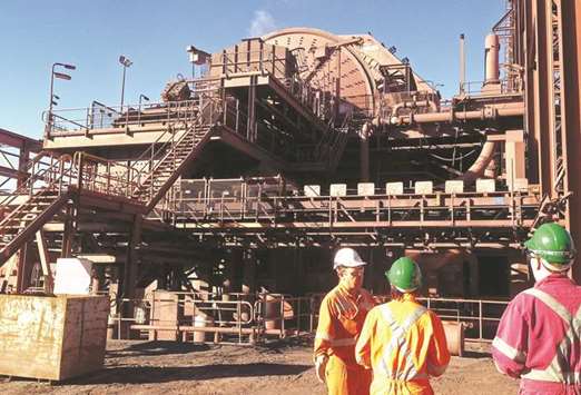 Officials stand near the grinding mill at BHP Billitonu2019s Olympic Dam copper and uranium mine located in South Australia. The companyu2019s incoming chairman Ken MacKenzie has held discussions with shareholders in Australia this week as part of a series of planned meetings thatu2019ll also take in the US and UK.