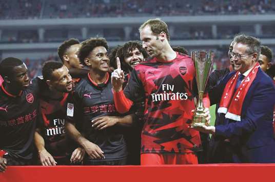 Careful of the food, boys! Arsenalu2019s Petr Cech celebrates with the trophy and teammates after the match against Bayern Munich during the International Champions Cup in Shanghai, China, yesterday.