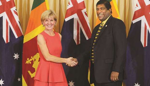 Sri Lankan Foreign Minister Ravi Karunanayake shakes hands with his Australian counterpart Julie Bishop during their meeting in Colombo yesterday.