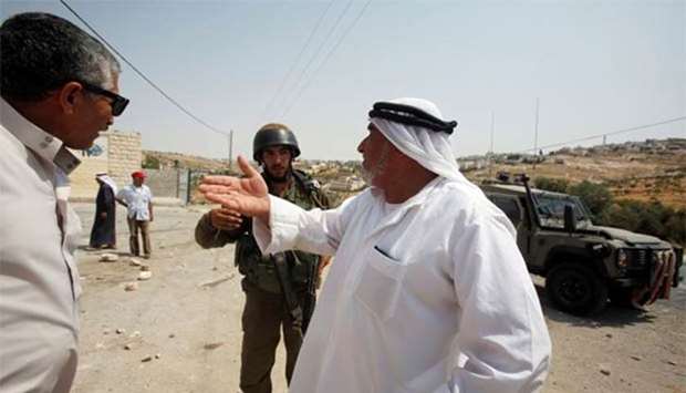 A Palestinian man argues with an Israeli soldier at the scene of an attempted stabbing attack by a Palestinian in the West Bank village of Tuqu near Bethlehem on Thursday.