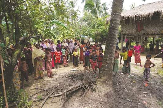 Rohingya villagers watch as international media visit Maung Hna Ma village, Buthidaung township, northern Rakhine state, Myanmar.