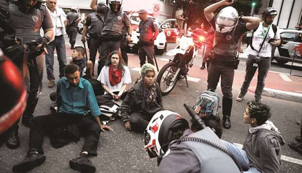 Demonstrators are detained by riot police during a protest against President Michel Temeru2019s proposed economic reforms in Sao Paulo yesterday.