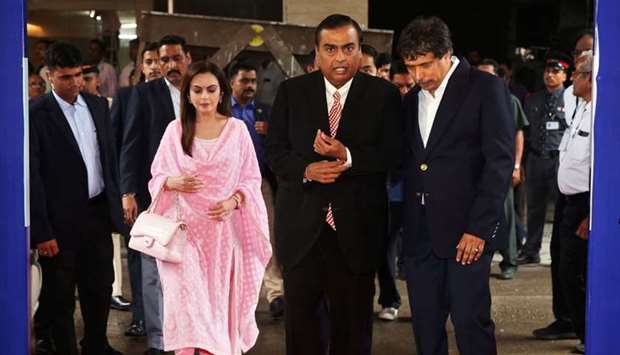 Mukesh Ambani, Chairman and Managing Director of Reliance Industries, arrives with wife Nita Ambani to address the company's annual general meeting in Mumbai.