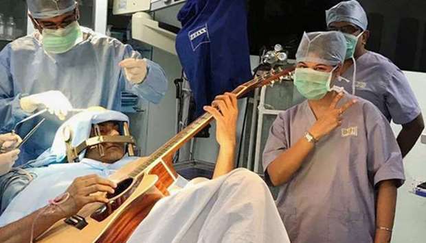 An image grab from a video that shows Abhishek playing guitar during the surgery. Courtesy: NDTV
