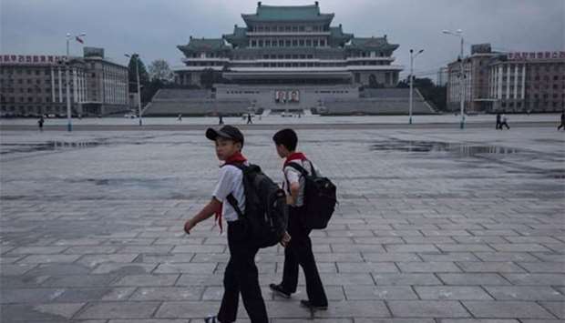 Two boys walk through Kim Il-Sung sqaure in Pyongyang on Friday.