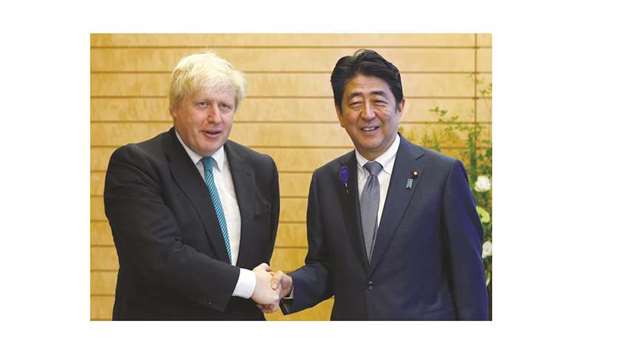 Britainu2019s Foreign Secretary Boris Johnson (left) with Japanu2019s Prime Minister Shinzo Abe in Tokyo. Johnson said London would continue to develop u2018commercial and economic relationsu2019 with Japan, adding: Japanese investments in the UK are at a record high since the Brexit vote last year.