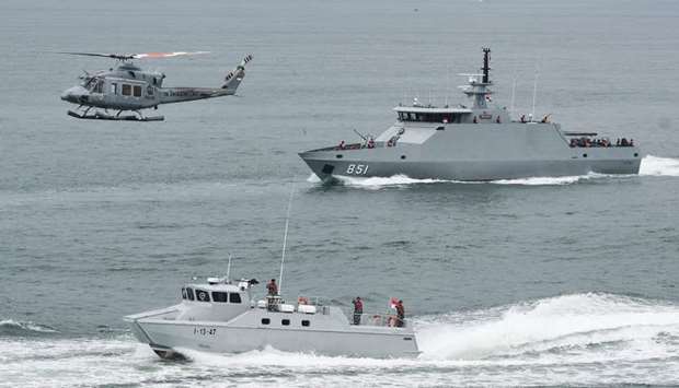 Indonesia navy soldiers on warship and helicopter are seen during the launch of coordinated patrols to beef up security