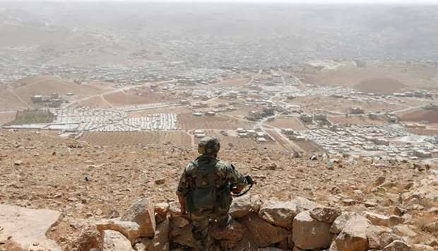 A Lebanese soldier carries his weapon as he stands at an army post in the hills above the Lebanese town of Arsal near the border with Syria, Lebanon. File picture:  September 21, 2016