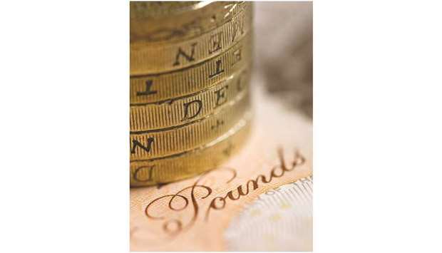 A stack of UK pound coins are arranged on a ten pound note in this studio photo taken in London. With the June 8 election weakening the ruling Conservative Partyu2019s position as formal negotiations to leave the European Union start, analysts remain sceptical on the poundu2019s longer-term outlook. Economic data has also been undercutting expectations, making the case for tighter policy debatable.