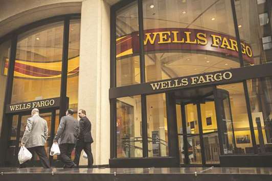 Pedestrians pass in front of a Wells Fargo & Co bank branch in New York. Wells Fargo surprised investors last week by withholding more than $90mn due to buyers of pre-crisis residential mortgage-backed securities.