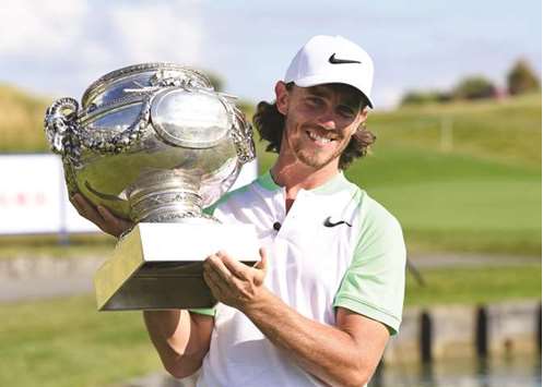 Britainu2019s Tommy Fleetwood poses with the trophy after winning the HNA Open de France in Guyancourt, near Paris. (AFP)
