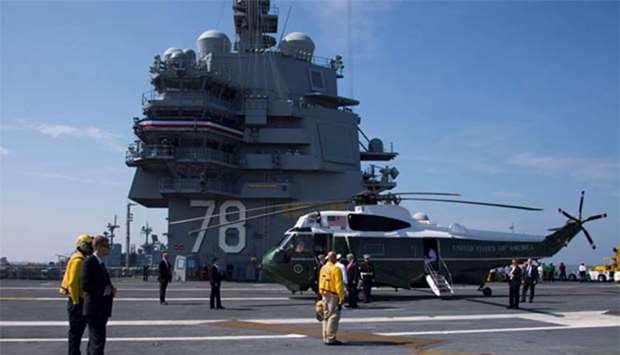 President Donald Trump is welcomed aboard the USS Gerald R. Ford in Norfolk, Virginia, on Saturday.