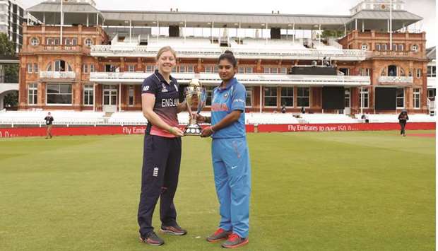 England captain Heather Knight (left) and India captain Mithali Raj pose with the Womenu2019s World Cup trophy at the Lordu2019s cricket ground in London yesterday. (Reuters)