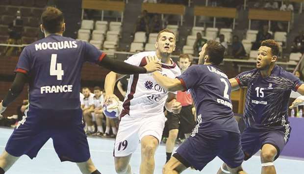 Action from the IHF Menu2019s Junior World Championship match between Qatar (in white) and France (in blue) in Algiers, Algeria, yesterday.
