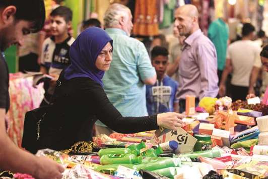 An Iraqi woman shops in the souq in the East of Mosul, yesterday.