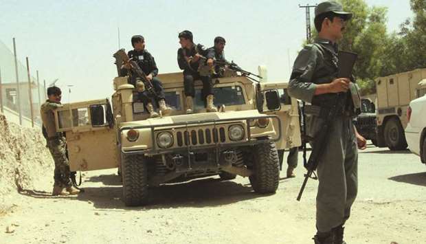 Afghan security personnel sit on atop an armoured vehicles amid an ongoing battle with Taliban militants in the Gereshk district of Helmand province yesterday.