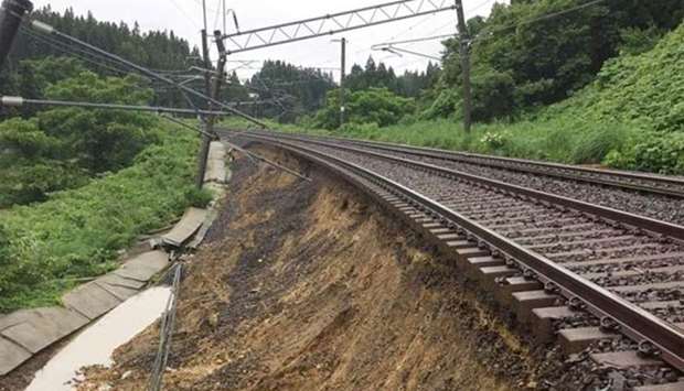 A collapsed railway track caused by heavy rain is seen in Daisen, Akita Prefecture.