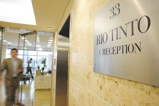 A man walks through the entrance from the reception area of Rio Tintou2019s head office in Melbourne. A cut by Rio Tinto to its full-year iron ore shipping guidance is set to bolster prices that have rebounded into a bull market on stronger-than-expected demand in China.