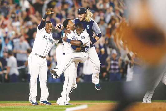 Seattle Mariners designated hitter Nelson Cruz (second left) celebrates with shortstop Jean Segura, centre fielder Guillermo Heredia and shortstop Taylor Motter following his walk-off RBI-single against the New York Yankees at Safeco Field. PICTURE: USA TODAY Sports