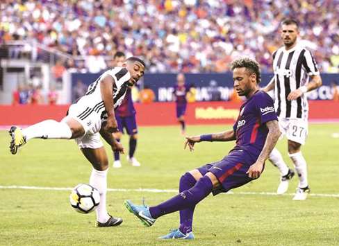 Barcelonau2019s Neymar takes a shot as Juventus defenders try and block him during the International Champions Cup 2017 at MetLife Stadium in East Rutherford, New Jersey.