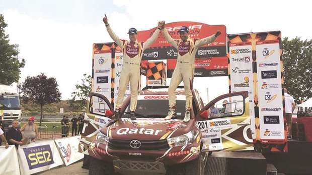 Qatari driver Nasser Saleh al-Attiyah (right) and French co-driver Matthieu Baumel celebrate their win in Baja Aragon, round seven of the FIA World Cup of Cross-Country Rallies, yesterday. (Twitter/BajaAragon)