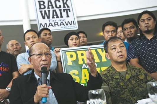 Defence Secretary Delfin Lorenzana (left) speaks while Lieutenant General Carlito Galvez, Western Mindanao military commander, listens during a dialogue between displaced Marawi residents and government officials in Iligan City on the southern island of Mindanao yesterday.