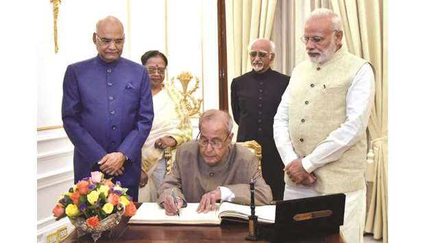 President Pranab Mukherjee signs the visitors book at Hyderabad House, during a farewell hosted by Prime Minister Narendra Modi for him in New Delhi yesterday. Also seen are president-elect Ram Nath Kovind and Vice President M Hamid Ansari.