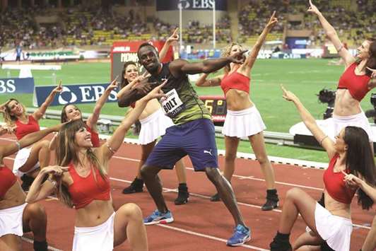Jamaicau2019s Usain Bolt (C) dances with pom-pom girls as he celebrates winning the menu2019s 100m event at the IAAF Diamond League athletics meeting in Monaco on July 21.