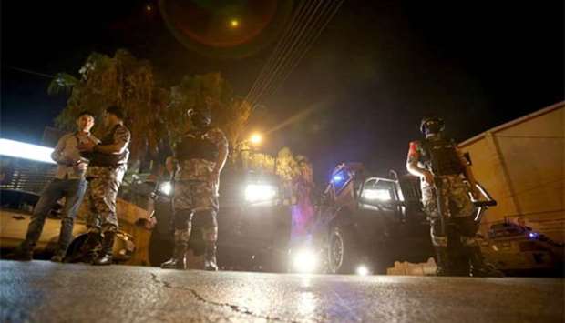 Security forces stand guard outside the Israeli embassy in Rabiyeh, Amman on Sunday night.