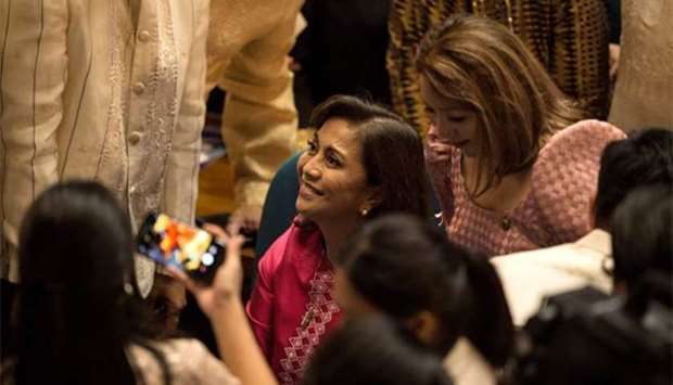 Philippine Vice President Leni Robredo (centre) looks up as she arrives at the House of Representatives in Manila on Monday to attend President Rodrigo Duterte's second annual State of the Nation Address.