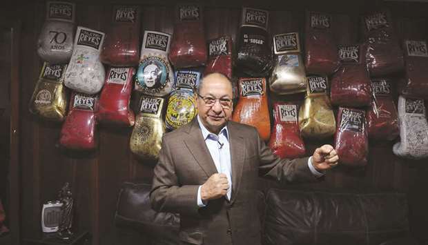 Alberto Reyes, son of Cleto Reyes founder of the iconic Mexican boxing gloves factory which bears his name, poses in front of a wall packed with autographed gloves at Reyes Industries headquarters in Mexico City. (AFP)