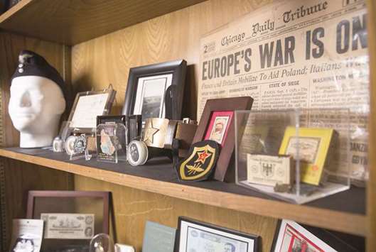 MEMORABILIA: Military memorabilia sits on the dresser of Andy Fancher, 18, at his home in Duncanville, Texas. Fancher has filmed countless hours of interviews with war veterans, including more than 30 WWII veterans.