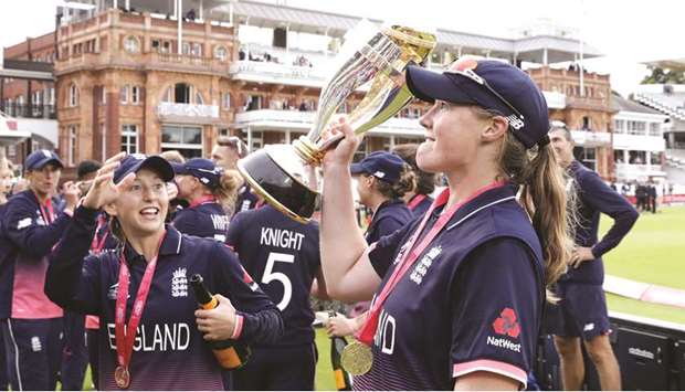 Englandu2019s Anya Shrubsole (R) raises the trophy after England won the ICC Womenu2019s World Cup cricket final against India at Lordu2019s on Sunday.