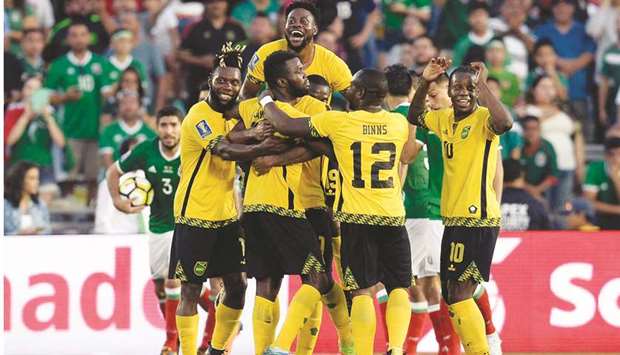 Jamaica celebrate the goal scored by forward Kemar Lawrence (second left) against Mexico during the second half at Rose Bowl.