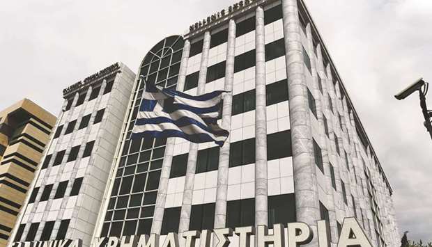 A Greek flag waves outside the Athens Stock Exchange. The country, which was the epicentre of the European sovereign crisis that began in 2009, is looking to sell five-year bonds, according to the bourse filing.