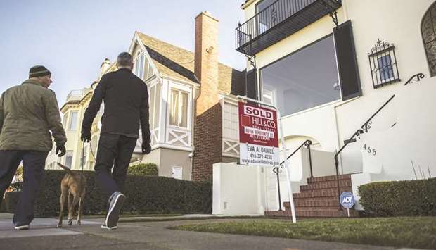 Pedestrians walk past a home for sale in San Francisco. US home resales volumes fell more than expected in June as a dearth of properties pushed house prices to a record high.