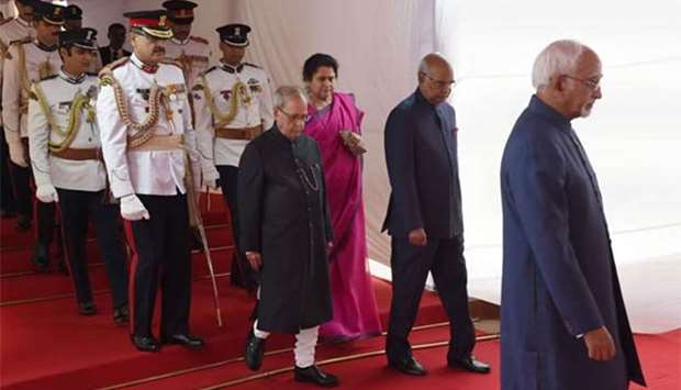 Ram Nath Kovind (second right) and outgoing President Pranab Mukherjee arrive ahead of the oath-taking ceremony at the Indian Parliament in New Delhi on Tuesday.