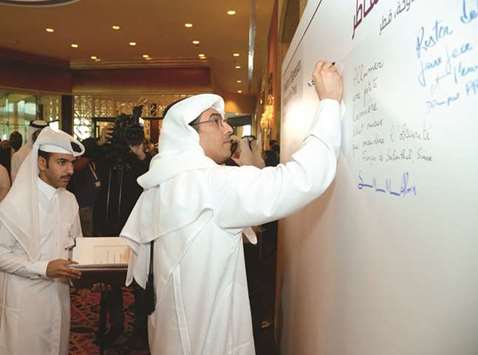 National Human Rights Committee chairman Dr Ali bin Smaikh al-Marri writes down his thoughts on media freedom on a board set up at the conference venue in Doha. PICTURE: Thajudheen