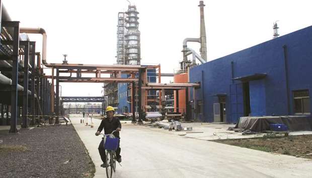 An employee rides a bike on a road near refinery plants of Chambroad Petrochemicals, in Shandong province. Chinau2019s state oil trader Unipec will develop u201creally strongu201d ties with Chinau2019s independent refiners, a company executive said yesterday.