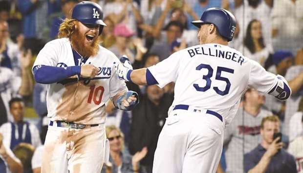 Los Angeles Dodgers first baseman Cody Bellinger (right) celebrates with third baseman Justin Turner after hitting a three-run home run against the Minnesota Twins during the eighth inning at Dodger Stadium in Los Angeles. PICTURE: USA TODAY Sports